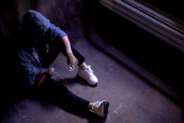 Drugged woman sitting on the floor with substance abuse, substance abuse, addiction, people and...