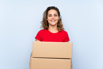 Young blonde woman holding a box to move it to another site