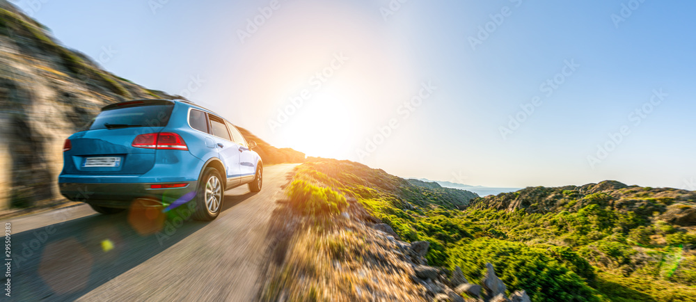 Wall mural suv car in spain mountain landscape road at sunset