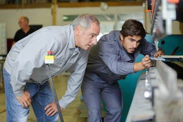 inserting solid plate in the machine to punch holes