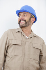 smiling worker in front of a construction site