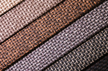 Colorful and bright fabric samples of furniture and clothing upholstery. Close-up of a palette of textile abstract diagonal stripes of different colors