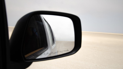 car mirror in the middle of a dessert, lost navigation GPS