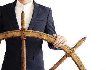 Businessman holding ship rudder. © Anton Sokolov