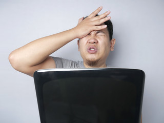 Asian Man Looked Regret and  Disappointed Expression Looking at Laptop