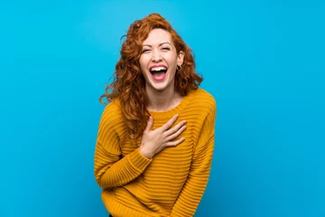 Fotobehang Redhead woman with yellow sweater smiling a lot © luismolinero