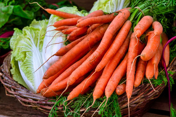 Sale of Chinese cabbage and carrots at a market stall