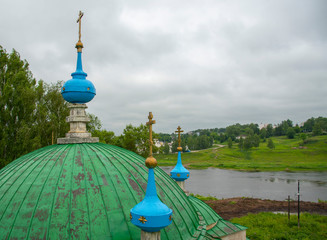 The dome of the Church with Golden crosses against the stormy sky.