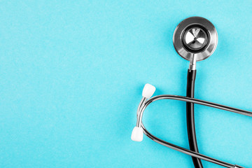 Stethoscope on blue background. Medical diagnostic device