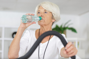 senior lady is very thirsty after training