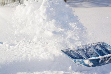 Shoveling snow with a shovel after snowfall