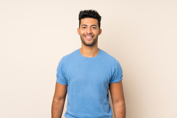 Young handsome man over isolated background keeping the arms crossed in frontal position