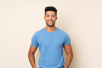 Young handsome man over isolated background laughing