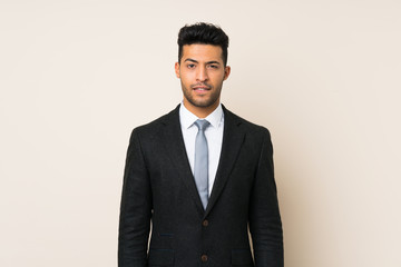 Young handsome businessman man over isolated background having doubts and with confuse face expression