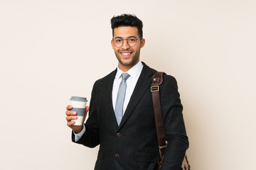 Young handsome businessman man holding coffee to take away over isolated background