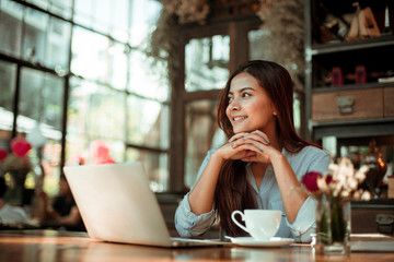 Asian woman drinking coffee in vintage color tone