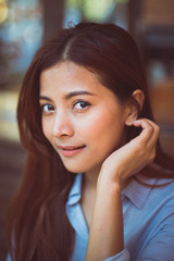 Asian woman drinking coffee in vintage color tone