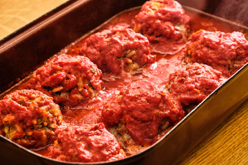 Meat balls with rice with tomato sauce in pan