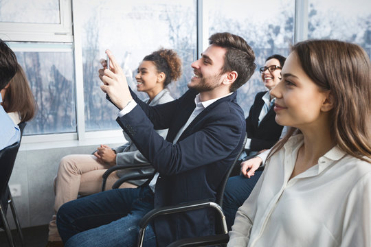 Business man filming lecture on smartphone camera - Powered by Adobe