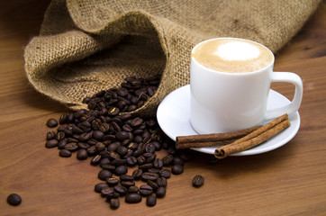 Coffee and coffee beans spotlight, on a wooden plate restaurant drinks food