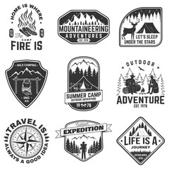 Obraz premium Set of outdoor adventure quotes symbol. Concept for shirt or logo, print, stamp. Vintage design with mountains, compass, rv trailer, camping tent, campfire, bear, tent and forest silhouette