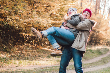 Traveler couple in love so fun in the forest. Concept of trekking, adventure and seasonal vacation.