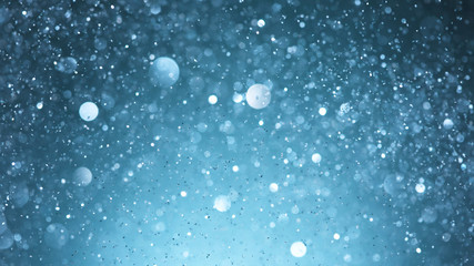 Abstract blue glittering background with blur dots.