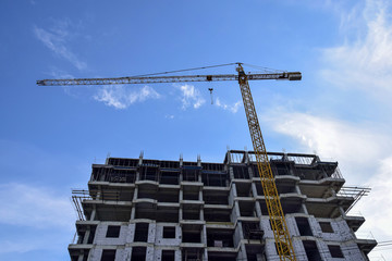 Construction of a new residential building  with use of tower crane. Real Estate, Residential Buildings Urban Mixed-Use Development Concept.