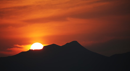 Brilliant orange sunrise over clouds.