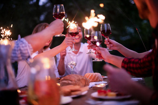 Happy Friends Having French Dinner Party Outdoor