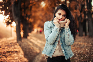 Beautiful model posing for the camera in the park.