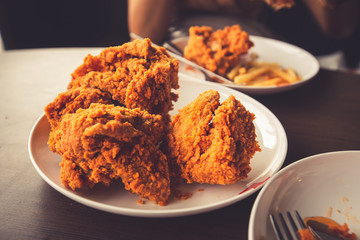 Close-up Fried chicken,freshfast on plate with fried chicken blur background,Woman eating fried chicken,Hungry,diet,Fat food,healthy food