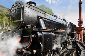 Fototapeta na wymiar Stanier Black Five LMS 5428 Steam Engine built in 1937 arriving at Goathland railway station North Yorkshire Moors Railway line England