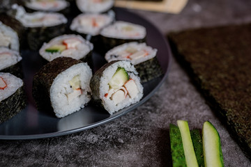 homemade sushi rolls on dark background front view
