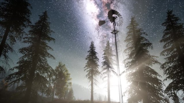retro windmill in mountain forest with stars. hyperlapse