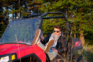 portrait of young man driving a off road buggy car