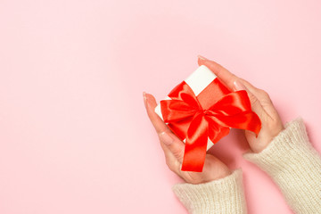 Christmas flat lay background on pink with present box.