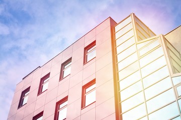 Modern office building detail, glass surface with sunlight