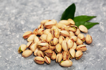 Heaps of pistachio nuts over concrete surface