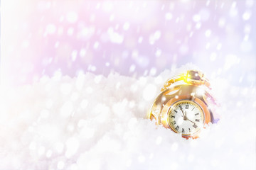 Fairytale magical background for New Year 2020 and Christmas - old round golden pocket retro watch lies in sparkling white snow and snowflakes. On the dial of the midnight countdown. Copy space.
