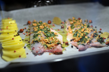 fresh raw bass fish in the oven