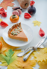 Pumpkin pie. Traditional american pie. Autumn theme. Halloween food. Thanksgiving Day. Light wooden background.