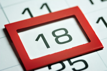 eighteenth day of the month highlighted on the calendar with a red frame close-up macro, mark on...