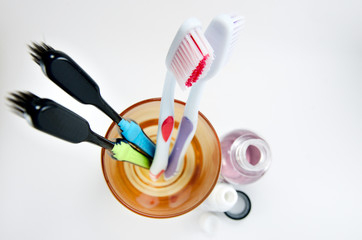 multi-colored toothbrushes in a glass on a light background top view, selective focus, mouthwash