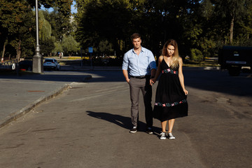 happy couple, man and woman, smiling. man holds woman and spins