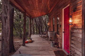 Front porch of a cabin in the woods at dawn