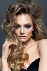 Fototapeta premium Beautiful young blond model with professional makeup, perfect skin, volume hairstyle