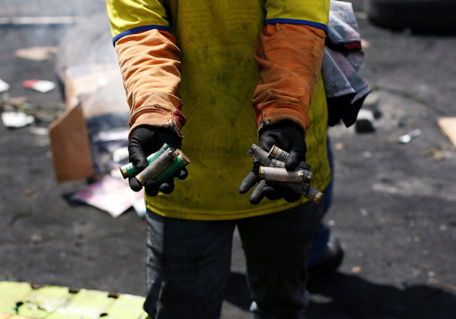 A demonstrator shows empty cartridges during clashes over Ecuador's President Lenin Moreno's austerity plan, in Quito