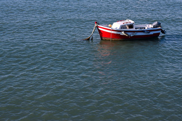 Naklejka premium Fishing boats next to the Constitution Bridge, called La Pepa, on the coast of the capital city of Cádiz. Andalusia. Spain. Europe. August 12, 2019