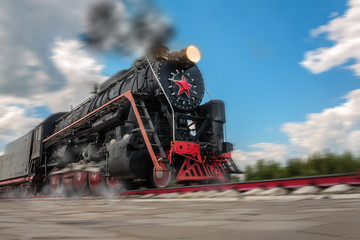 vintage steam train hurtling at speed along the rails close-up, retro vehicle, steam engine